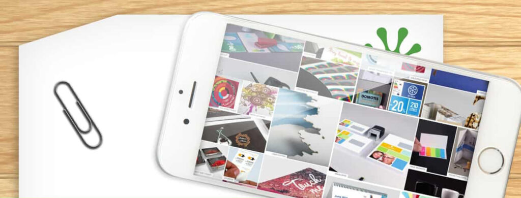 Smartphone displaying colourful design images on paper