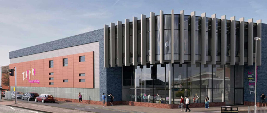 Modern building with glass facade and parked cars.