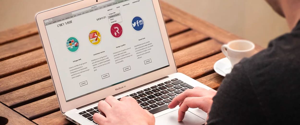 Person browsing website on laptop at cafe