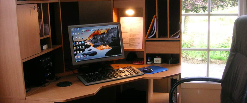 Modern home office desk with computer setup.