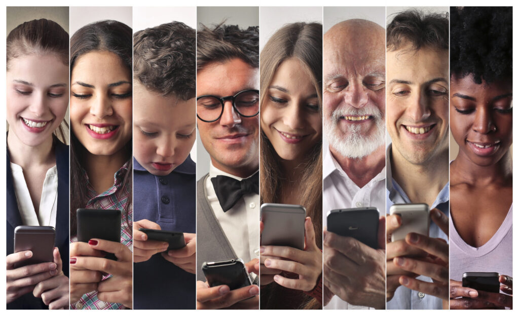 Diverse people smiling while using smartphones.