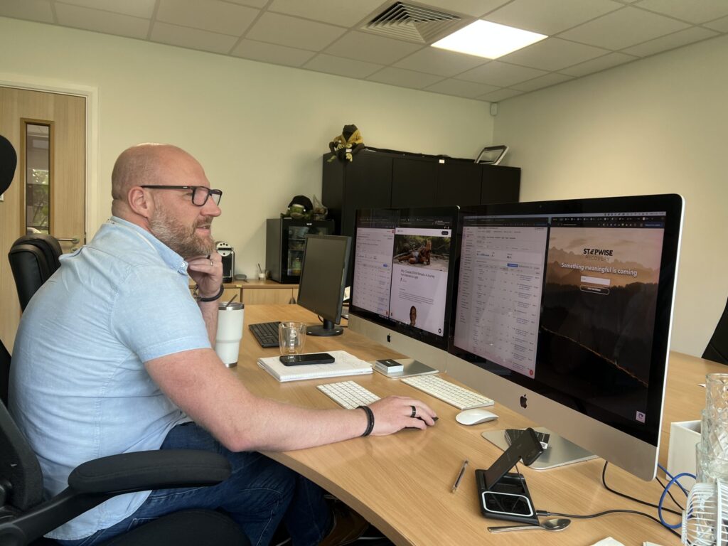 Man working at desk with multiple screens