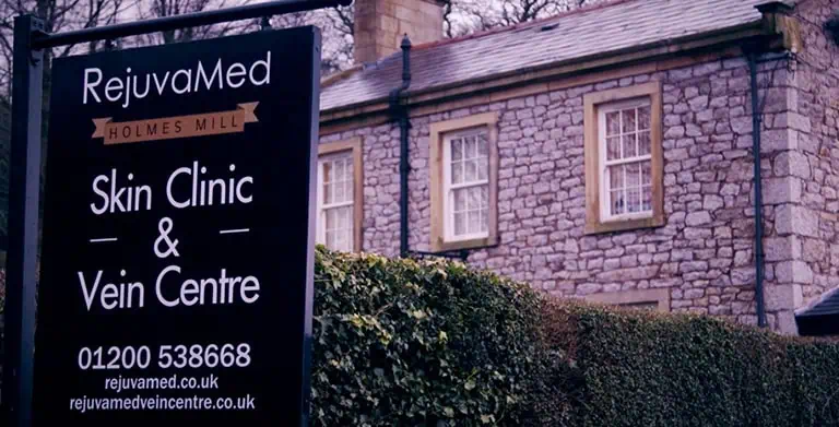 RejuvaMed Skin Clinic sign in front of stone house