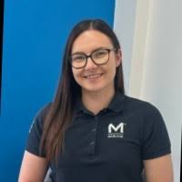 Smiling woman in blue polo shirt with logo