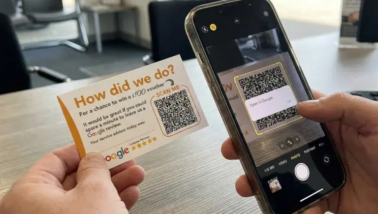 Scanning QR code for review and voucher opportunity.