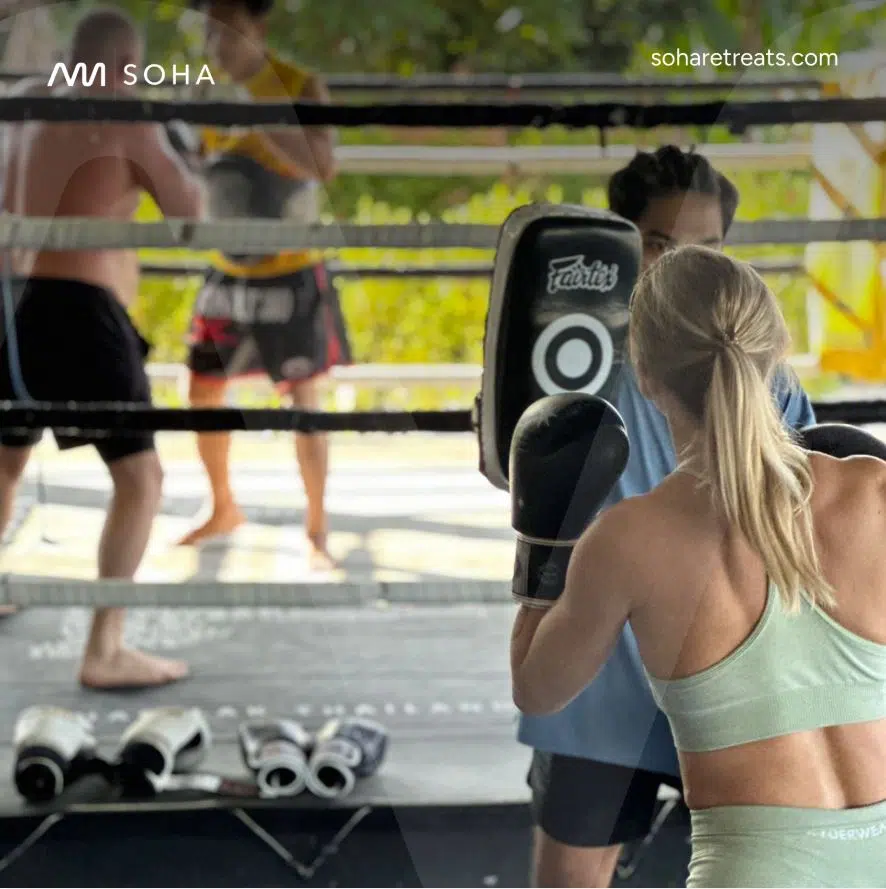 Fertile.Digital | SOHA Retreats – Strategic Infrastructure Transformation Delivering 50% Cost Reduction & 65% Performance Improvement People training in a boxing ring outdoors.